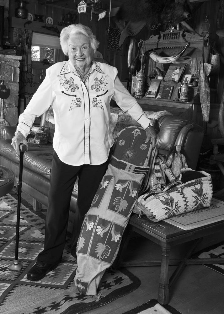 Ellie stands among artifacts collected by her family over 88 years during the Hamilton Stores era in Yellowstone National Park.