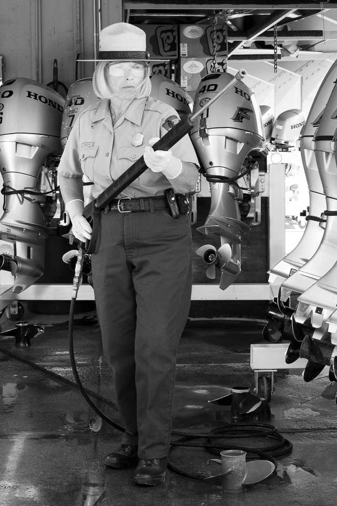Margie holds a spray gun used to clean and disinfect boats headed for Yellowstone waters.