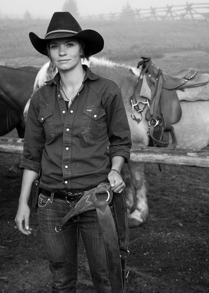 Stacy stands in the Canyon horse corral, where wranglers prepare 50 to 60 horses a day for trail rides in Yellowstone National Park.
