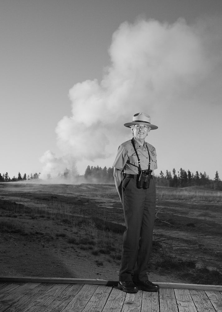Katy stands in front of Old Faithful in Yellowstone, where she served as park ranger from 2002 to 2011.