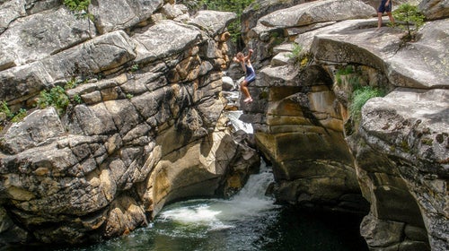 Taking the 20 foot leap in Devil's Punchbowl outside of Aspen, Colorado.