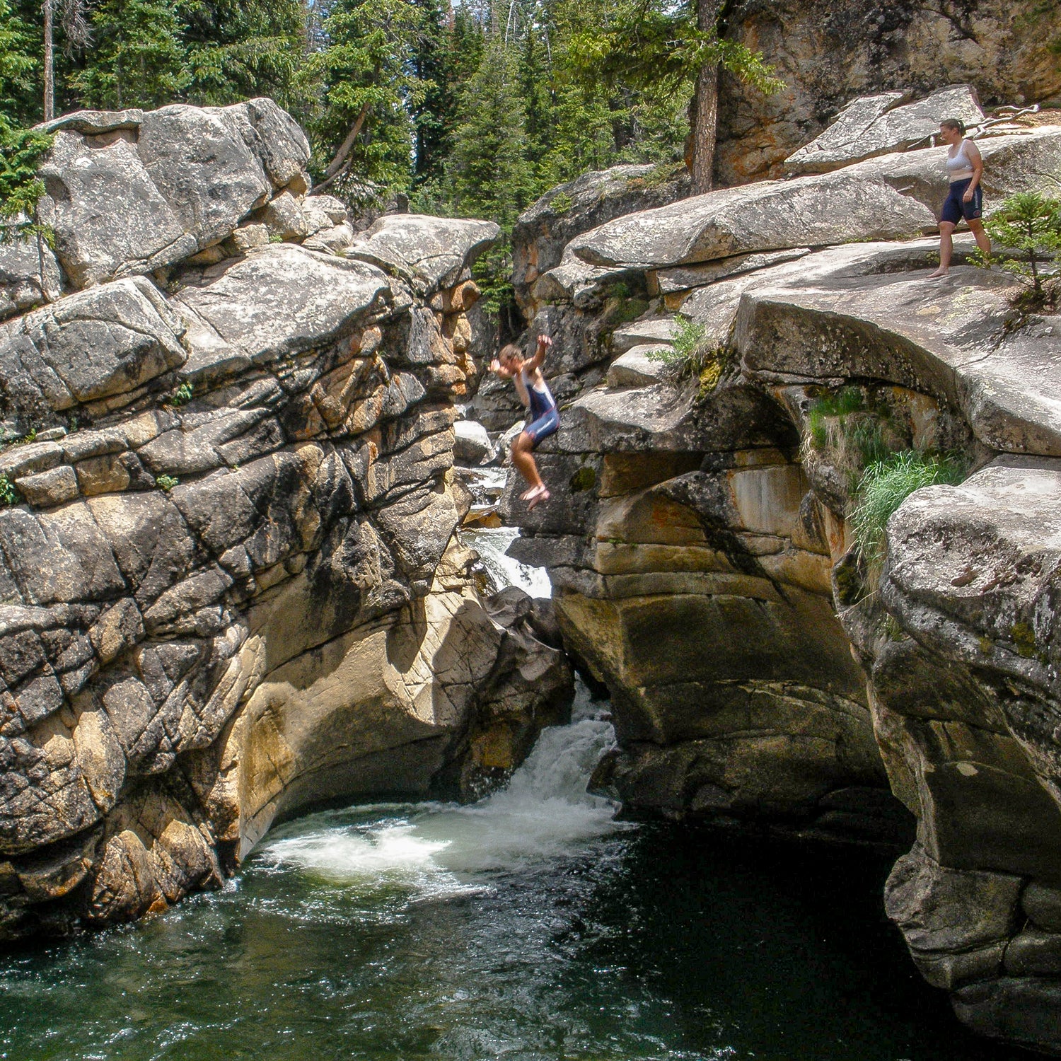 Taking the 20 foot leap in Devil's Punchbowl outside of Aspen, Colorado.