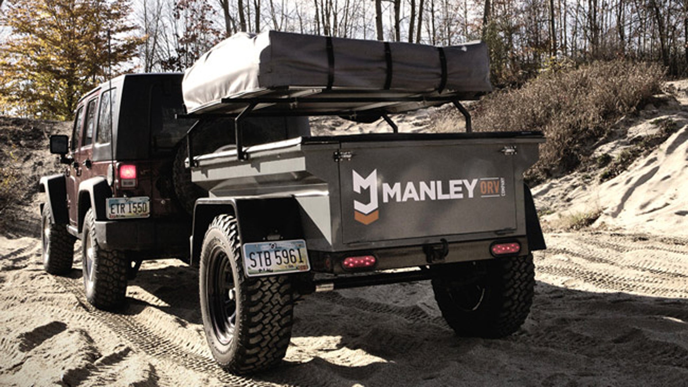 An expedition trailer with a built in rooftop tent.