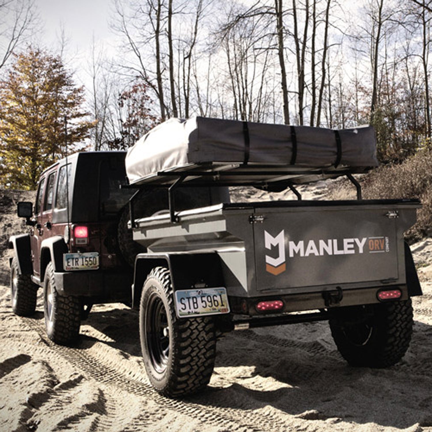 An expedition trailer with a built in rooftop tent.