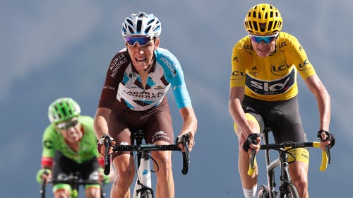 Britain's Chris Froome, wearing the overall leader's yellow jersey, right, Colombia's Rigoberto Uran, left, and France's Romain Bardet cross the finish line during the eighteenth stage of the 2017 Tour de France.