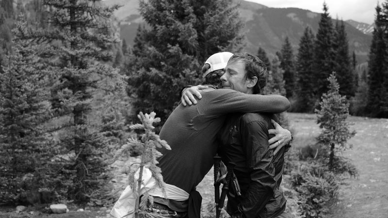 Adam receives a hug of encouragement from his coach Jason Koop on the Hardrock course.