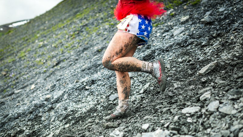 Mud cakes the shoes and legs of Marion Woods of Anchorage, AK.
