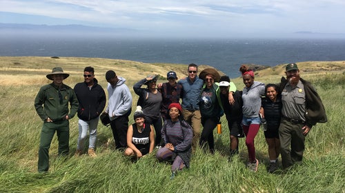 The group, atop cliffs above the Pacific ocean.