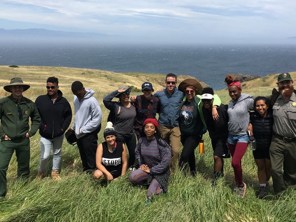 The group, atop cliffs above the Pacific ocean.