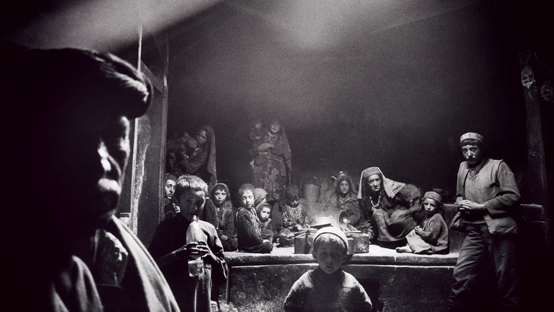 Fierce Hospitality: Wakhi villagers gather for an evening meal inside a communal kitchen in the village of Sarhadd.