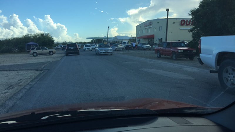 A grocery store in Turks and Caicos is a scene of frantic chaos.