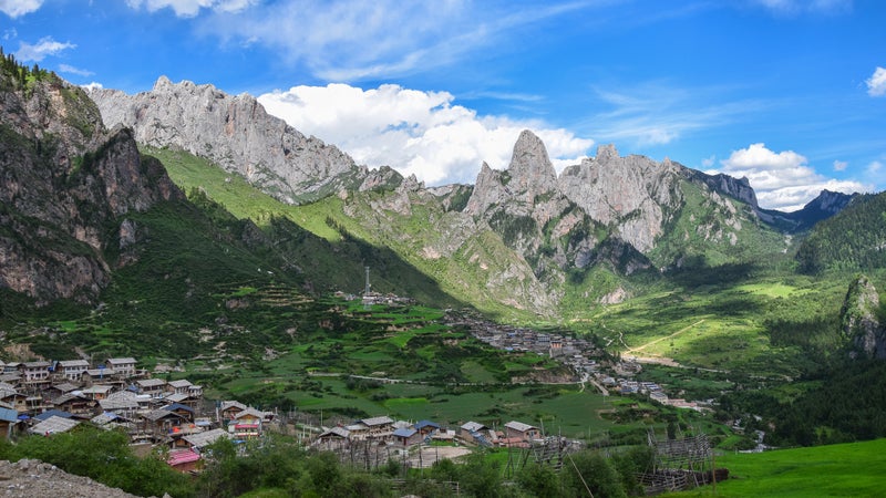 Afternoon mountain shadows cast over Zhagana, where most villagers are racing to open guesthouses.