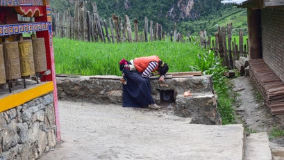 A local villager circumambulates Zhagana's local monastery, praying as she goes, a daily ritual for many Tibetans.