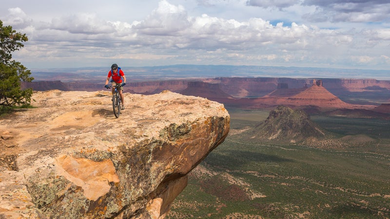 A mountain biker riding above Castle Valley on the Porcupine Rim Trail near Moab, Utah.