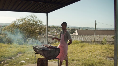 Siyabonga cooks shisanyama at a car wash in KwaMashu, South Africa.