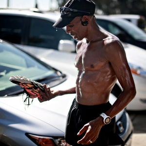 Meb Keflezighi looks over one of his shoes after a training run in San Diego, CA.