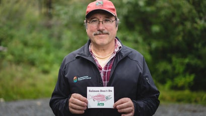 Guy Archibald of the Southeast Alaska Conservation Council (SEACC) holds a sticker designed and distributed by SEACC. The org, whose mission is to protect the waters and lands of Southeastern Alaska, was in need of visual content of the community and ecosystems impacted by the Constantine project. They submitted a request through Give a Shot, where Peak Design ultimately decided to take on the project themselves.