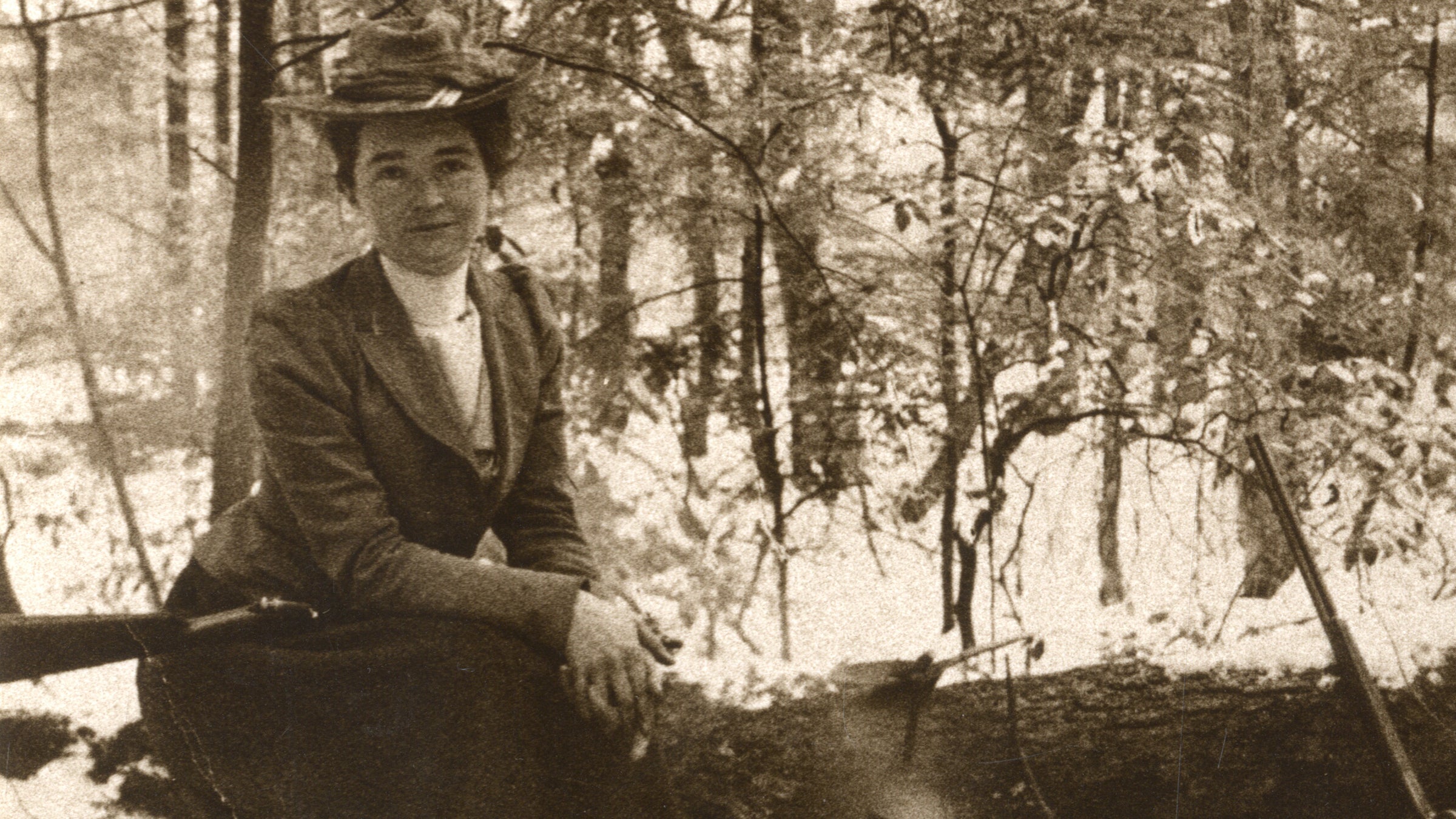Hubbard poses on a log during an expedition.