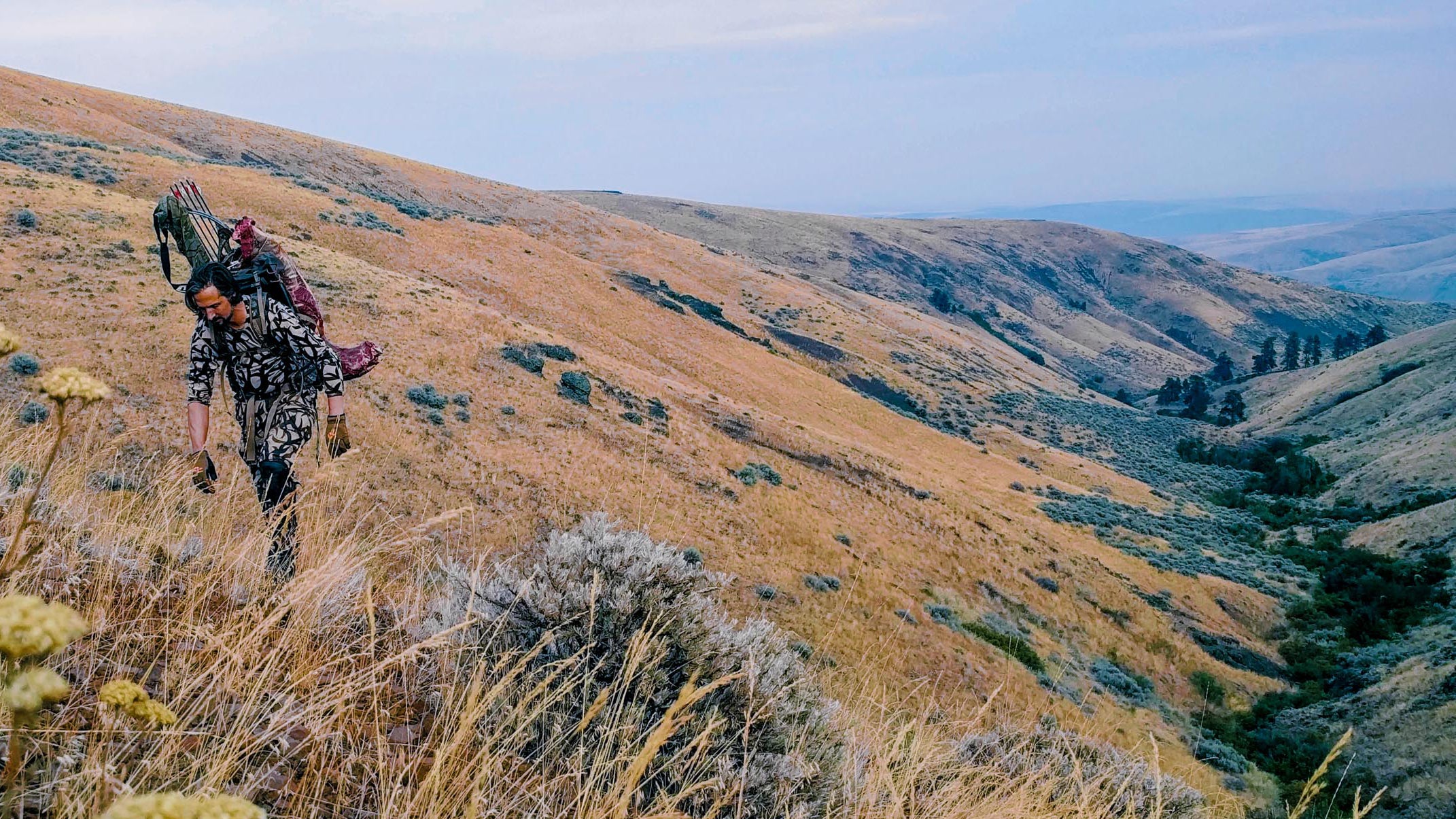 Griff packs out an elk torso. All our elk fell in that valley, which sounds convenient, until you realize we had to get them out of there. In terrain like this, there's only one way to do that...