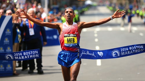 Meb Keflezighi crosses the finish line to win first place in the men's race of the 118th Boston Marathon.