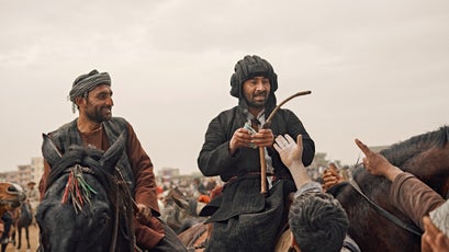 A Tajik general hands out money during a match in Mazar-e-Sharif.