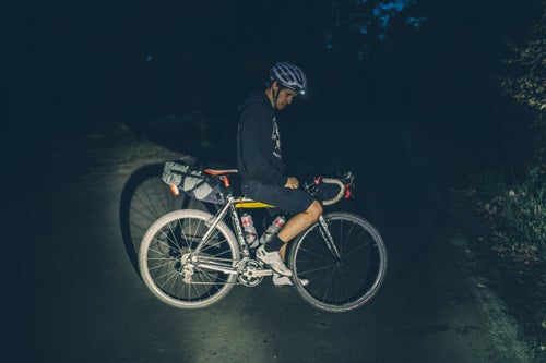 Daniel Golden, owner of Search and State, an NYC-made cycling apparel brand, stopping to adjust his headlamp and take a breather.