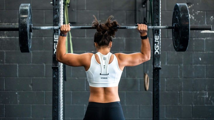 photo of women from the back lifting weights in gym