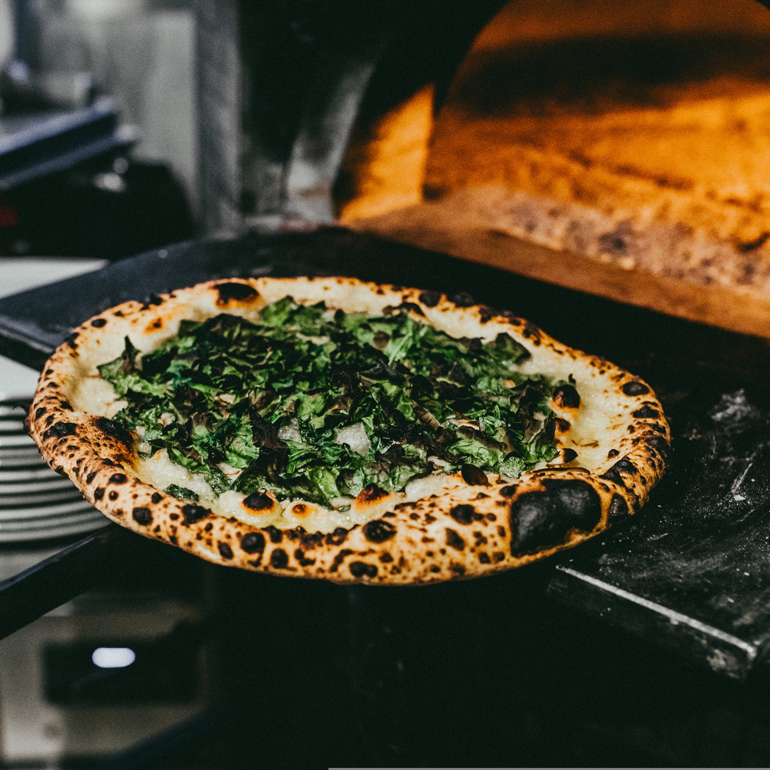 Krar says Pizzicletta's SS-145 pizza combination of Gorgonzola, charred kale, and lemon juice atop a perfectly charred crust is a masterpiece.