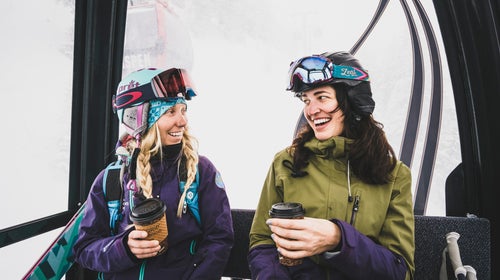 Sammy Podhurst and Janelle Huelsman fuel up on the gondola before a day of powder skiing on Aspen Mountain, Colorado.