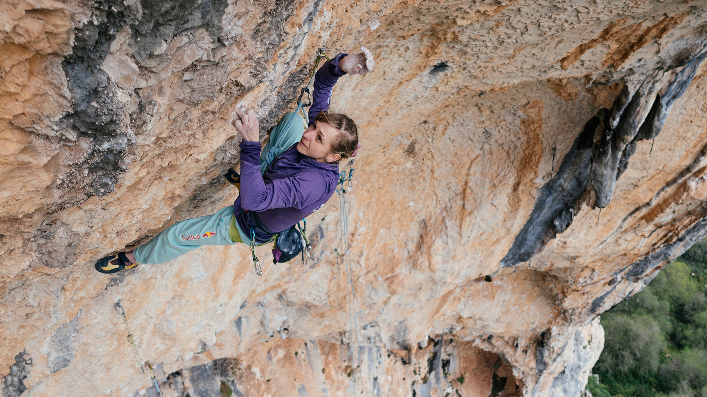 Angela Eiter on a tough traverse on crimps in the second pitch of La Planta de Shiva.