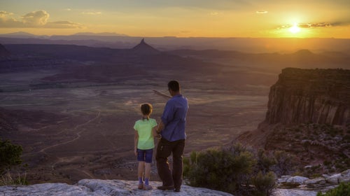 A father and daughter look out over Bears Ears National Monument.