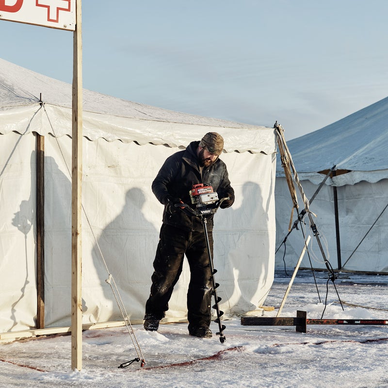 Volunteers drill 20,000 holes in the two-foot-thick ice.