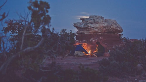Ace Kvale and Craig Childs huddle by a campfire one night during filming.