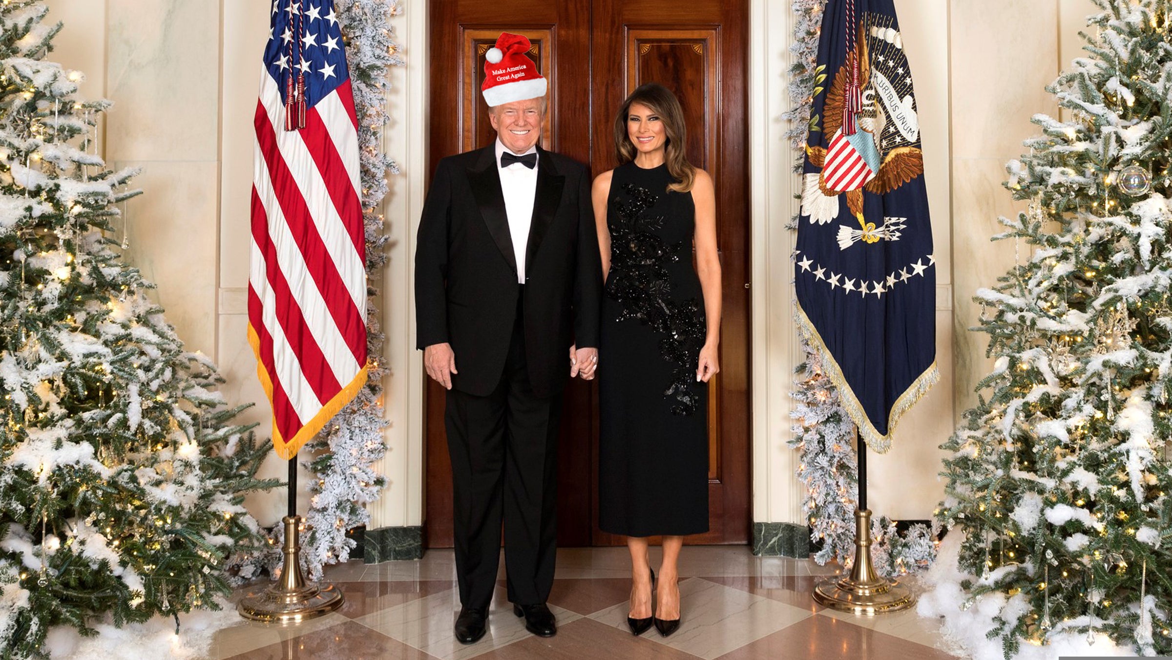 President Donald J. Trump and First Lady Melania Trump are seen Tuesday, December 5, in their official 2017 Christmas portrait, in the Cross Hall of the White House in Washington, D.C.