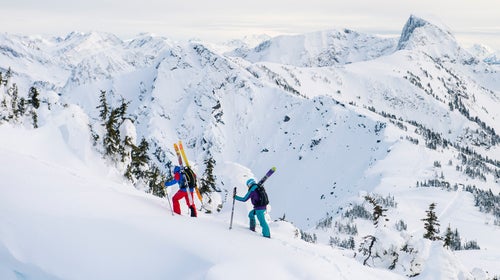 Tristan Knoertzer and Kim Havell hiking on a snowy day in Revelstoke, British Columbia