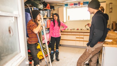 Sarah McNair-Landry (left) talks with Lin, Jonatan, and Eddie (hidden) in Matty's workshop early in training.