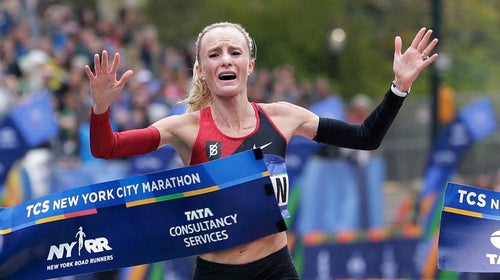 Shalane Flanagan crosses the finish line of the New York City Marathon, becoming the first American woman to win the race in 40 years.