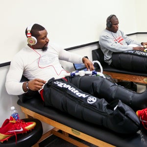 NaVorro Bowman and Frank Gore of the San Francisco 49ers refresh their legs with a Normatec treatment in the locker room prior to Super Bowl XLVII  February 2013.