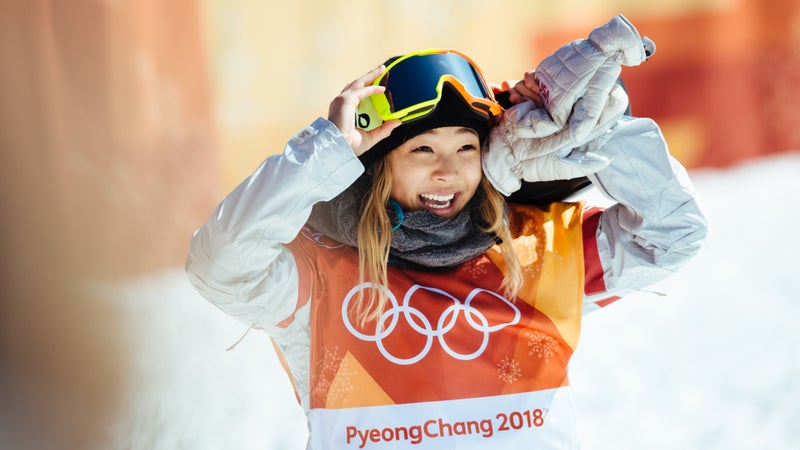Chloe Kim reacts to her first run score of 93.75—enough to secure gold. Kim's victory lap, however, improved her score to a near-perfect 98.25.