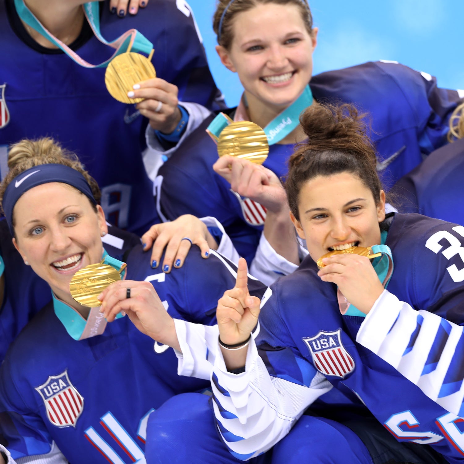 The USA Women's Hockey team celebrates after beating Canada for a gold medal.