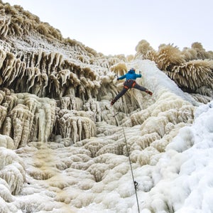 Lake Superior creates extremely unique ice formations. The combination of the wind and the spray from waves slamming into the cliffs below covers vegetation around the top of the cliff line. Climbing these formation is a formidable challenge  for the Midwest adventure seekers. Here Joseph Thill climbs Bridal Veil Falls rated WI 4 in Munising, Michigan.