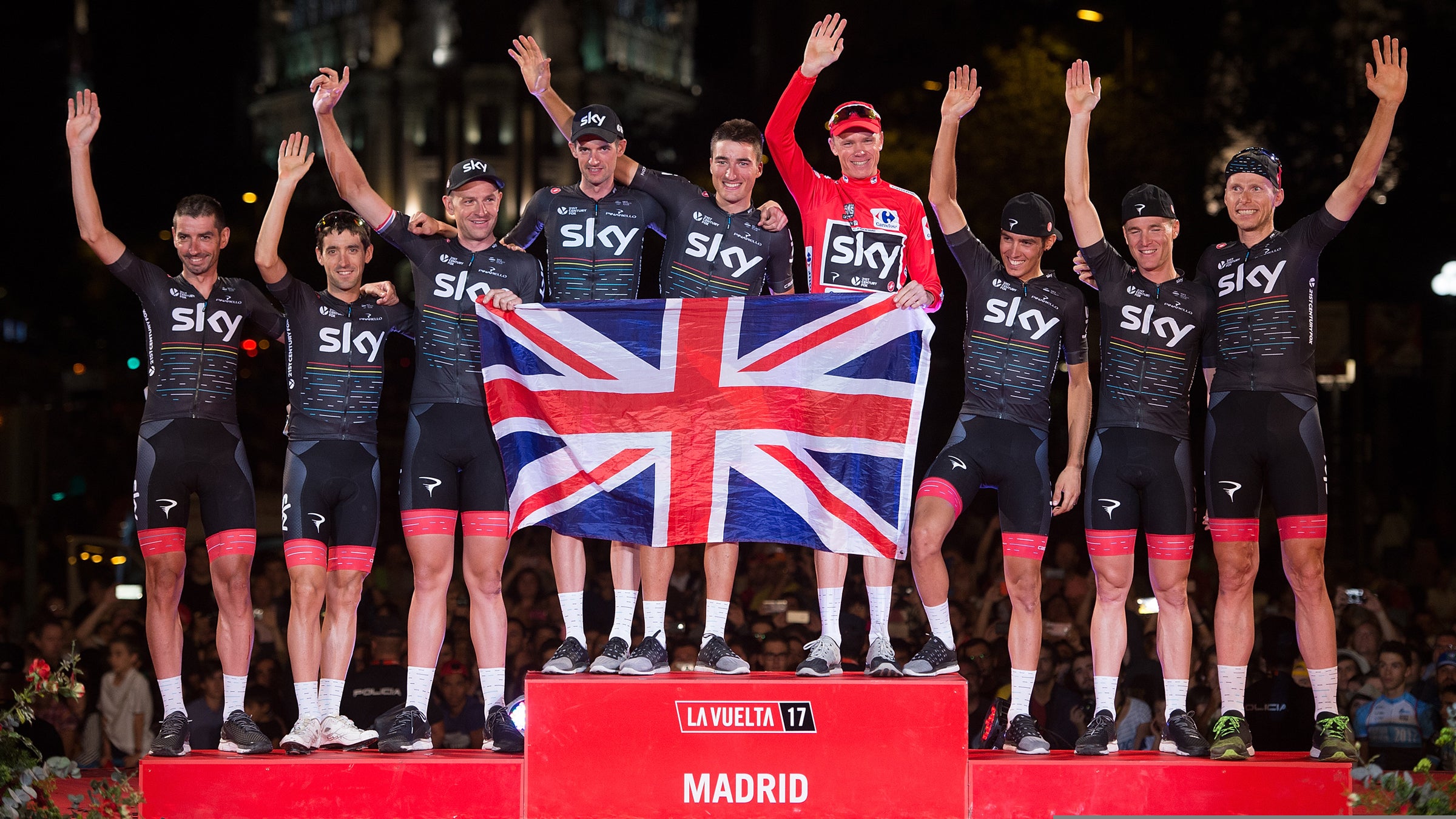 Britain's Chris Froome of Team Sky celebrates with teammates on the podium after winning the Vuelta a Espaa.