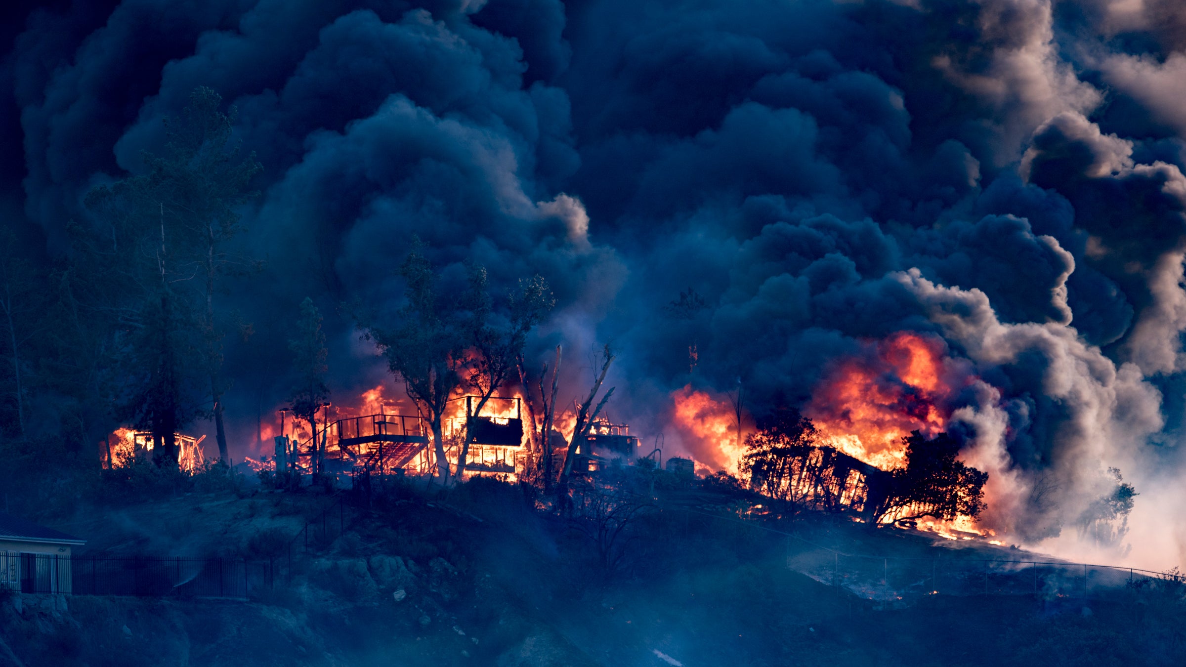 A house is engulfed in flames as the Creek Fire burns in Los Angeles, California on December 5, 2017.