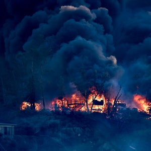 A house is engulfed in flames as the Creek Fire burns in Los Angeles, California on December 5, 2017.
