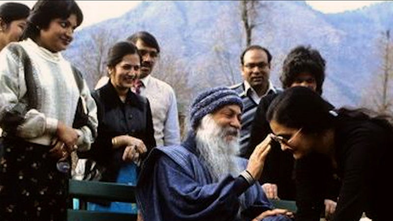 The guru Bhagwan Shree Rajneesh and some of his followers.