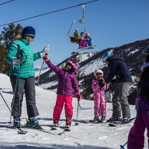Emily Coombs gives a young skier some encouragement before heading down the hill. Coombs hopes introducing children to skiing at a young age will help diversify the ski club as the kids grow, improve, and look to the next level of skiing.