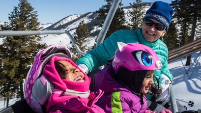 Coombs jokes with young foundation skiers recently while riding the chairlift at Snow King Mountain. Foundation participants ski every Saturday through the winter at Snow King with the help of instructors.