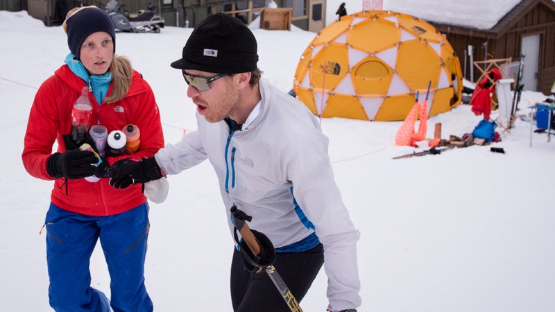 Foote steps off on the final lap at about 8:00 a.m. on Sunday, March 18. Alyson Gnam hands him fluids and food as he moves.