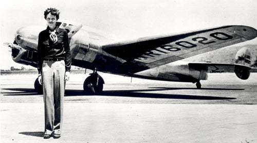 Amelia Earhart standing in front of the Lockheed Electra in which she disappeared in July 1937