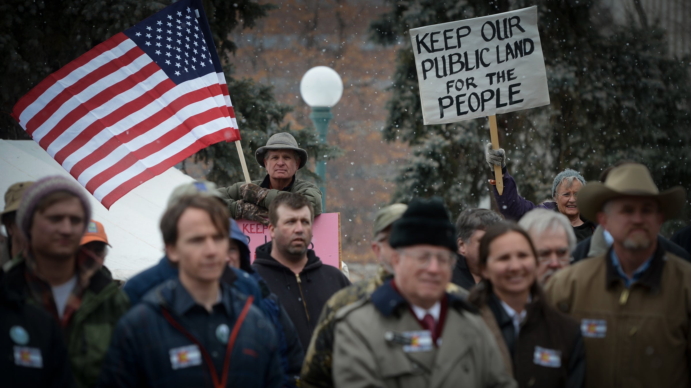File Image: Outdoor enthusiasts Chris Madson (holding American flag) and Nancy Nixon (holding sign) show their support during a rally at the Denver, Colorado Capitol February 25, 2015 against the transfer and sale of public lands.